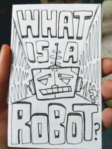 Minizine cover of What is a Robot? Cover illustration: a cartoon swuare robot face looking puzzled.