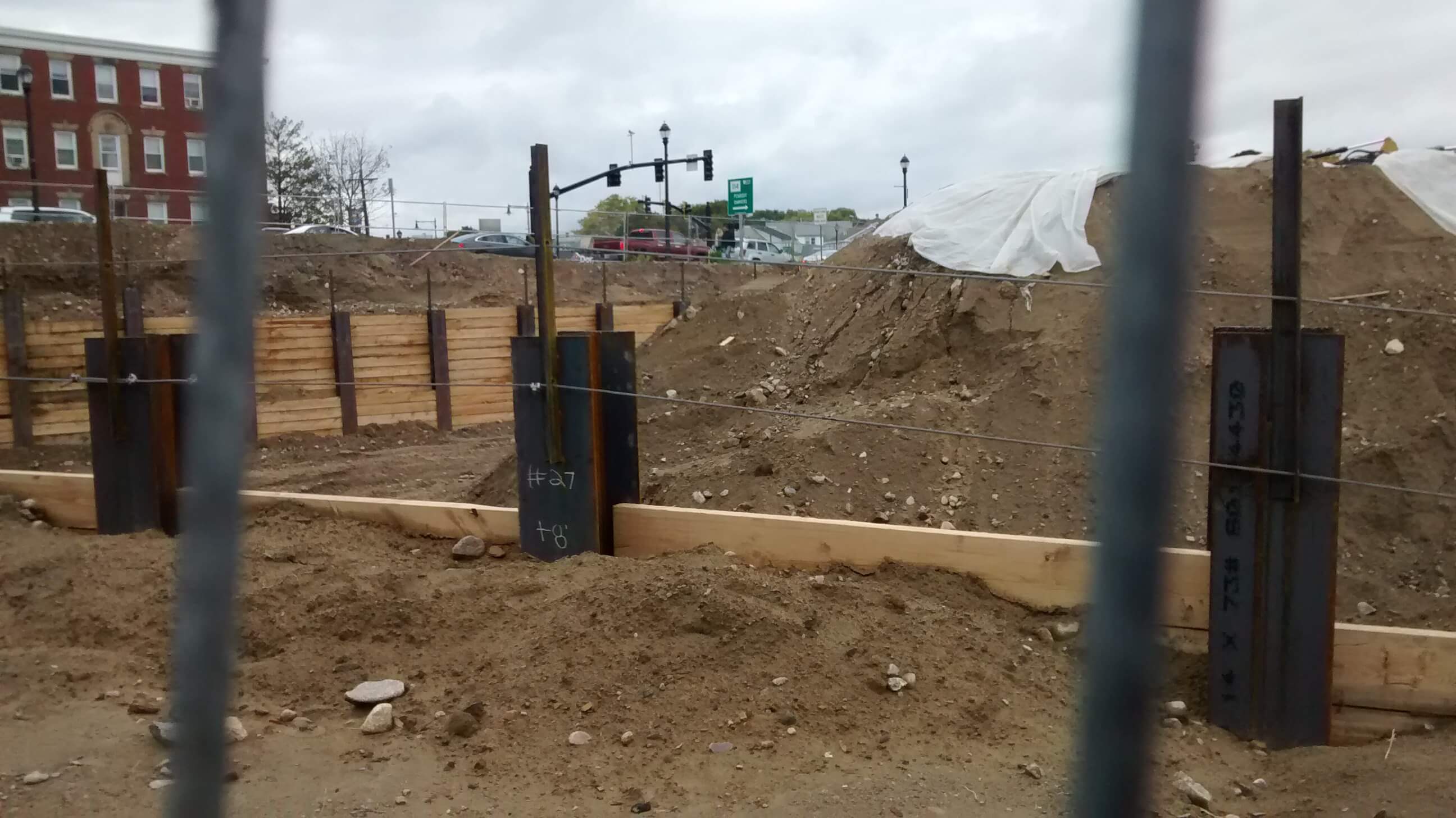 A construction site with an intersection in the distance.