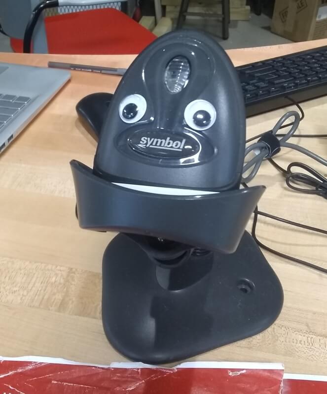 Googly eyes on a barcode scanner, like the scanner is the mouth.