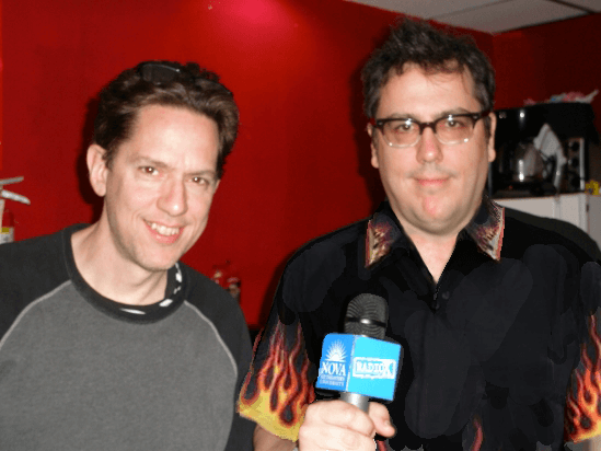 A Guy-Fieri style flame pattern is photoshopped onto John F's black shirt.